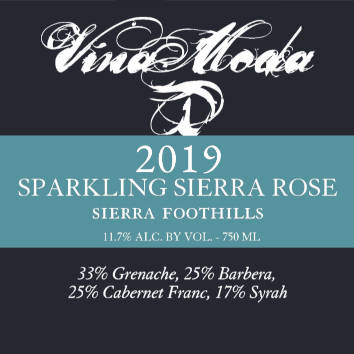 A pour of Sparkling Sierra Rose next to bottle